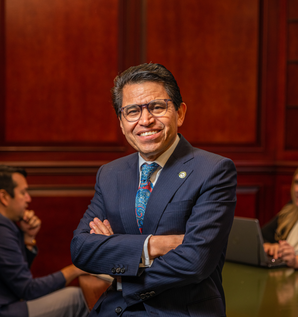 College president standing with arms crossed