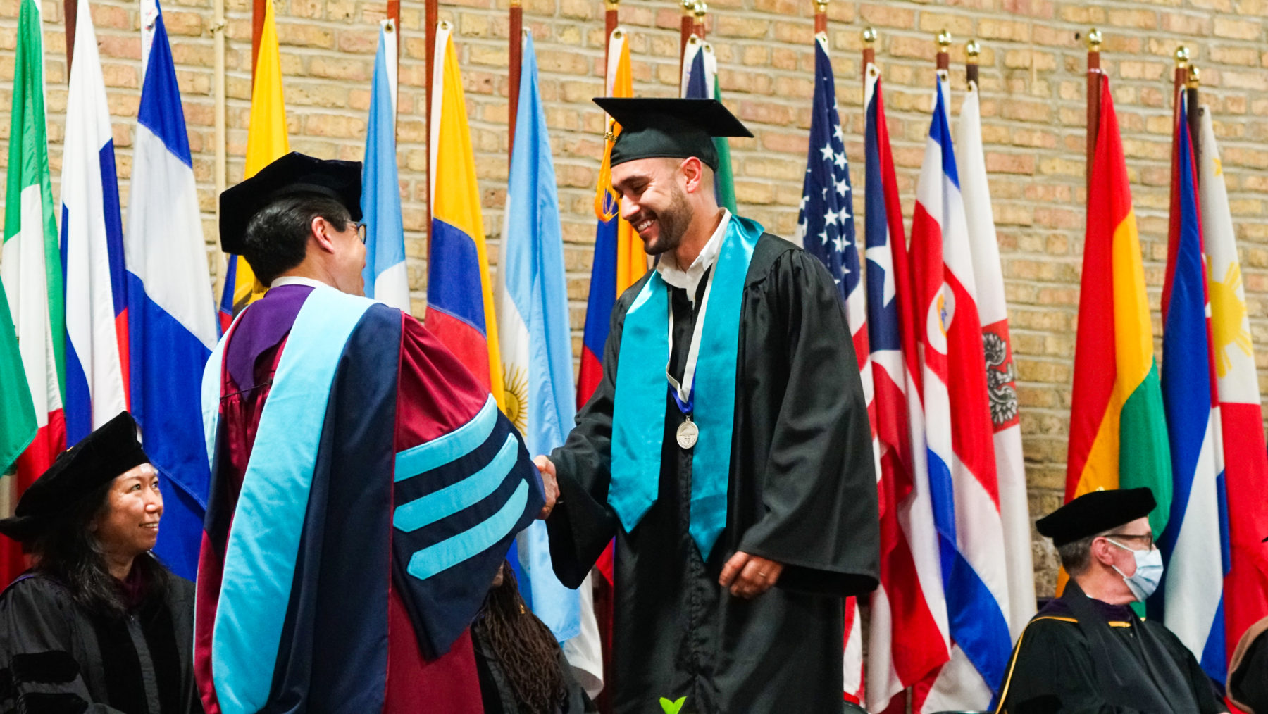 A student is handed their degree. 
