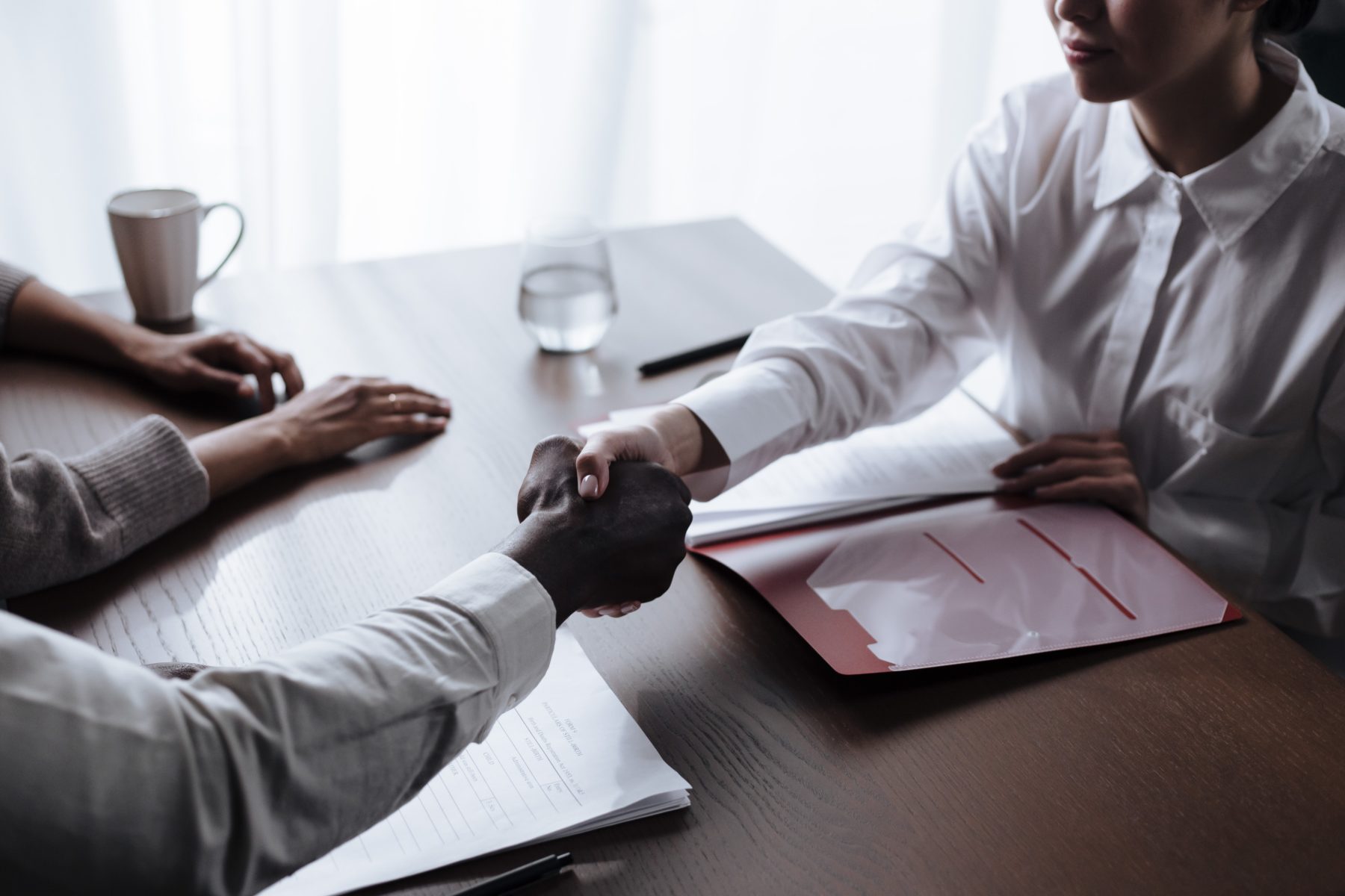 A man shaking hands with a social worker.
