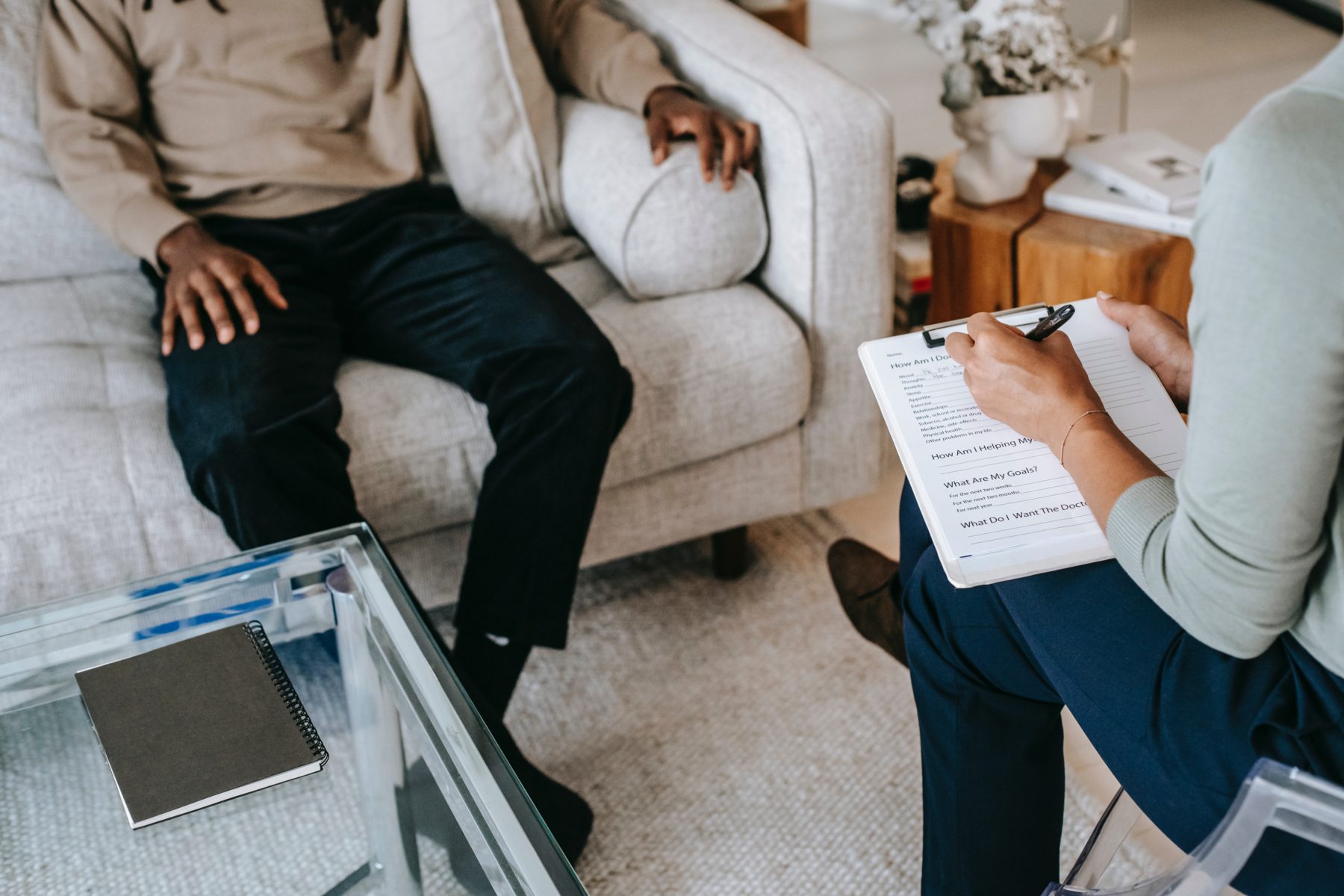 A psychologist and their client during a therapy session. 