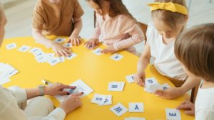 A group of toddlers holding letters from the alphabet.
