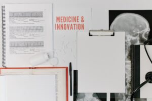 An x-ray, medical charts, and a spilled bottle of pills over the words “Medicine and Innovation”