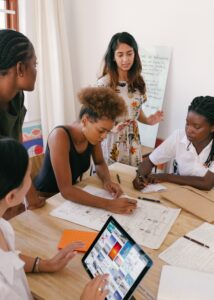 A group of businesswomen looking over charts.