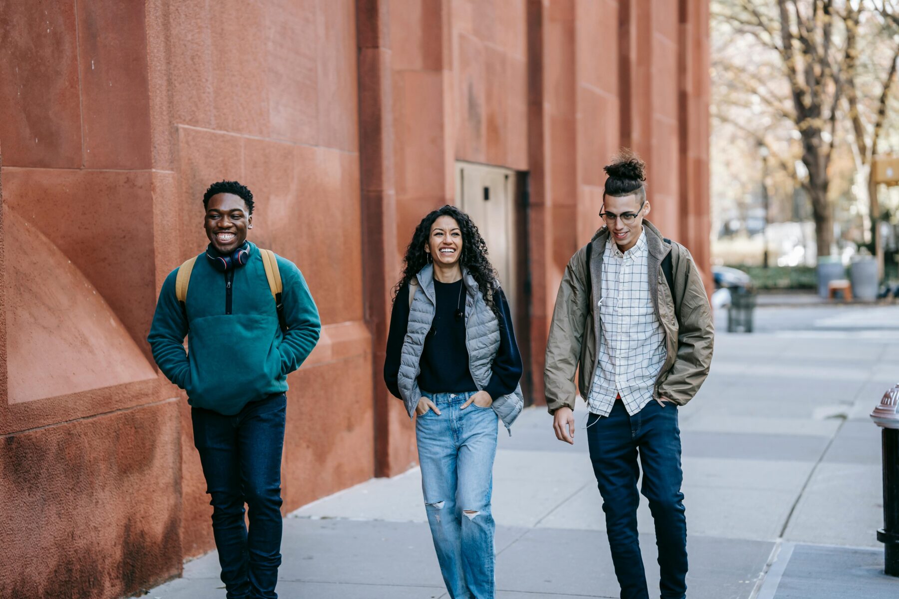 Three college students walking through their campus.