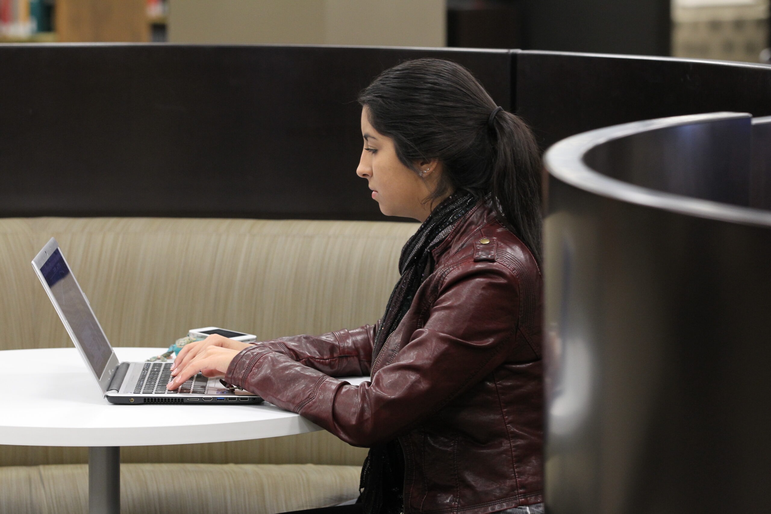 A young woman at Lewis University working hard.